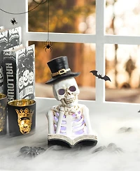 Glitzhome 10.25" H Halloween Lighted Resin Skull Reading Book Table Decor