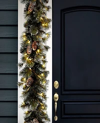 National Tree Company 9' x 10" Glitter Pine Garland with Cones, Snowflakes and 100 Clear Lights
