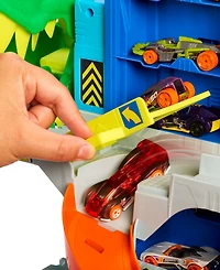 Hot Wheels 1:64 scale City Ultimate T-Rex Garage with 2 Toy Cars & Storage for 50+, Race & Stunt, Dino Nemesis