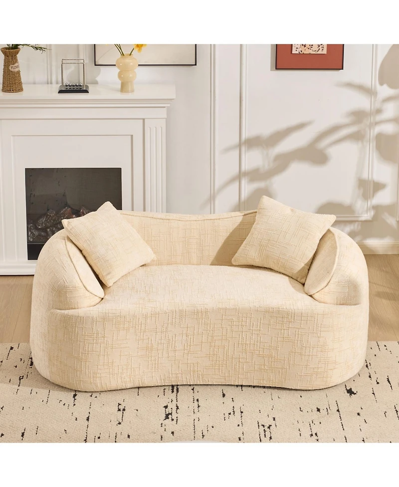 Streamdale Furniture Beige curved two-person compress sofa with armrests and two pillows.
