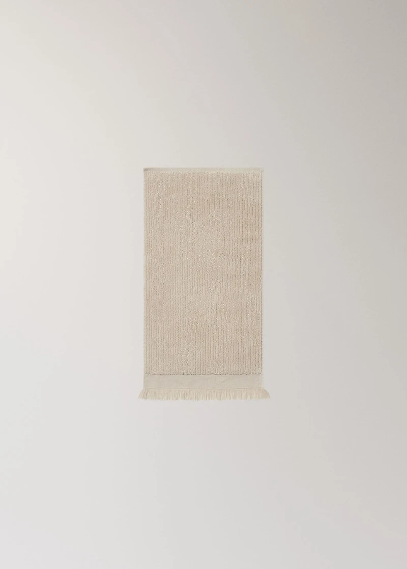 Textured guest towel with fringes