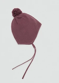 Knitted bonnet with tassel