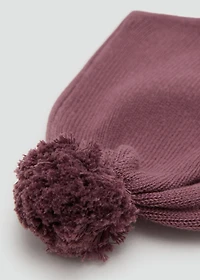 Knitted bonnet with tassel