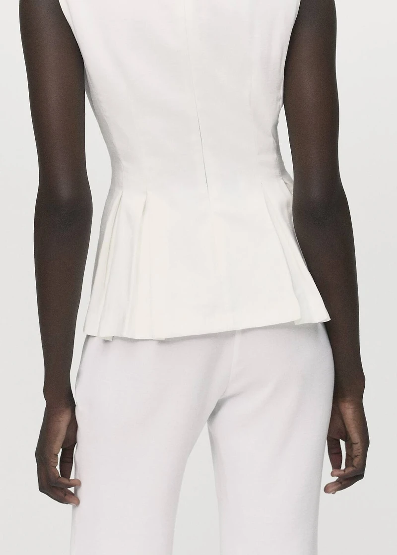 Peplum top with pleat detail