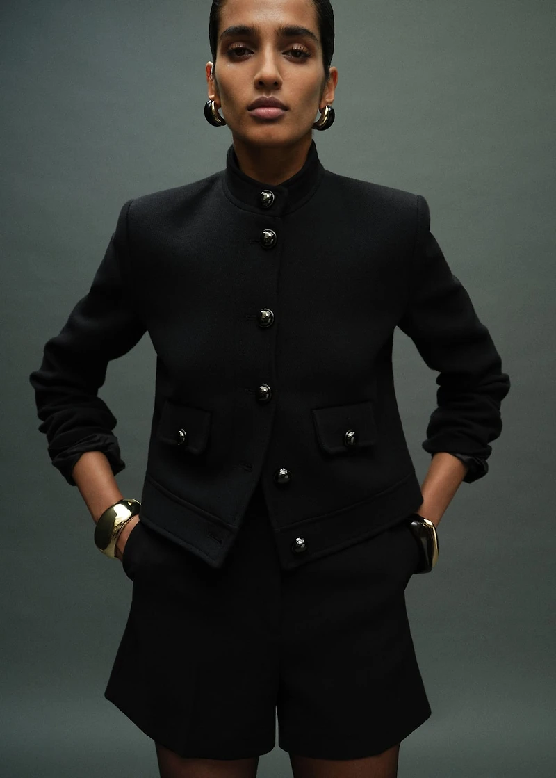 Jacket with jewel-button strip collar