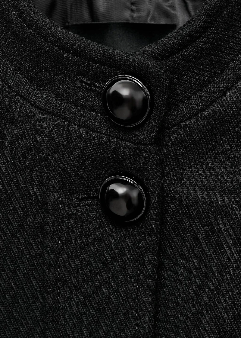 Jacket with jewel-button strip collar