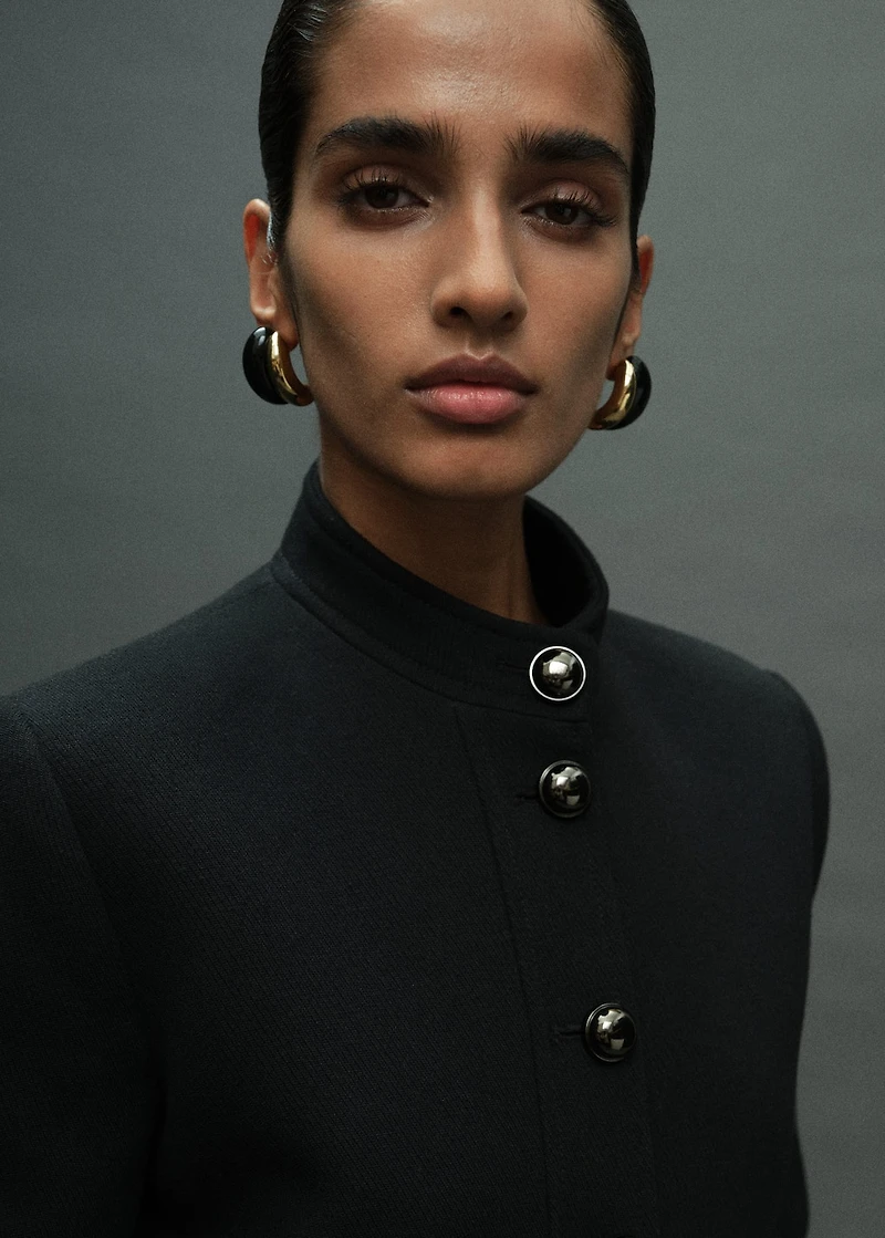 Jacket with jewel-button strip collar