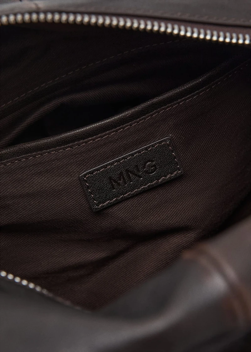 Leather clutch bag with charms