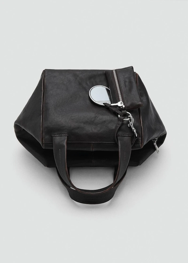 Leather clutch bag with charms