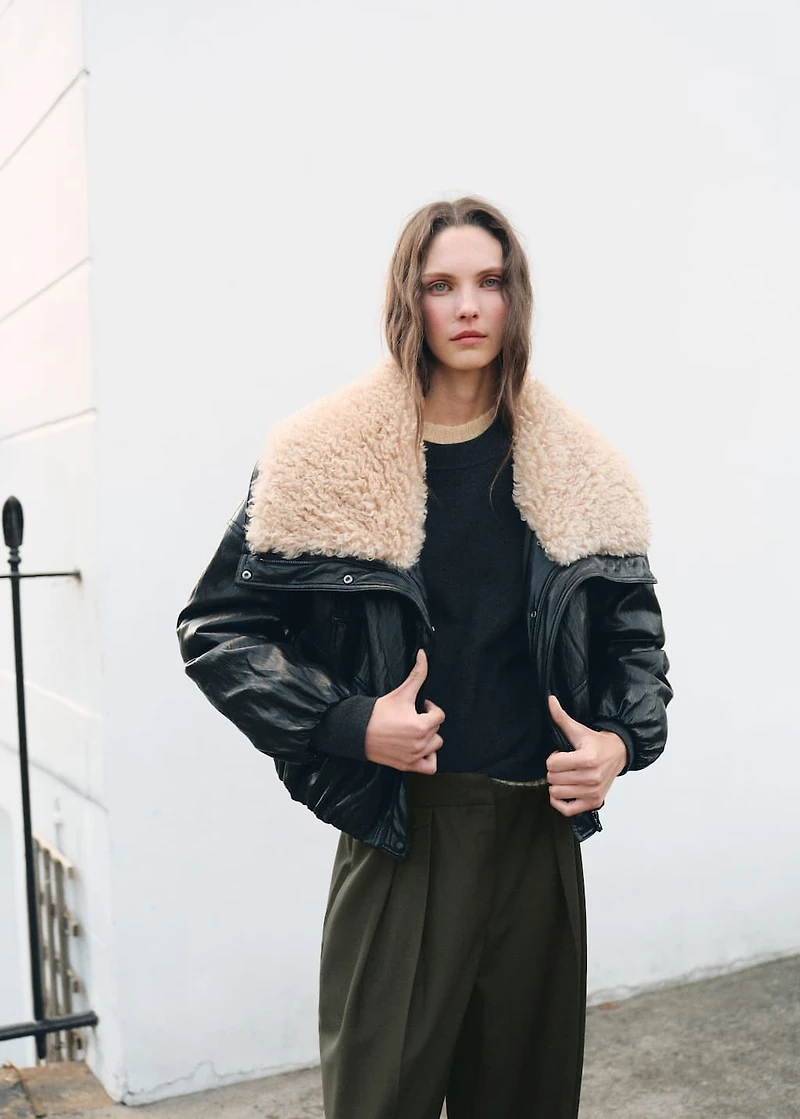 Trousers with pleats and button detail