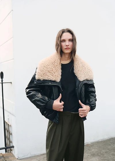 Trousers with pleats and button detail