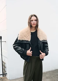 Trousers with pleats and button detail