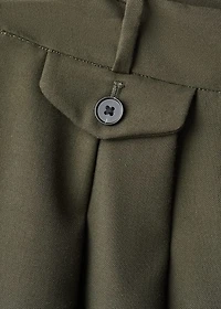 Trousers with pleats and button detail