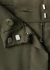 Trousers with pleats and button detail