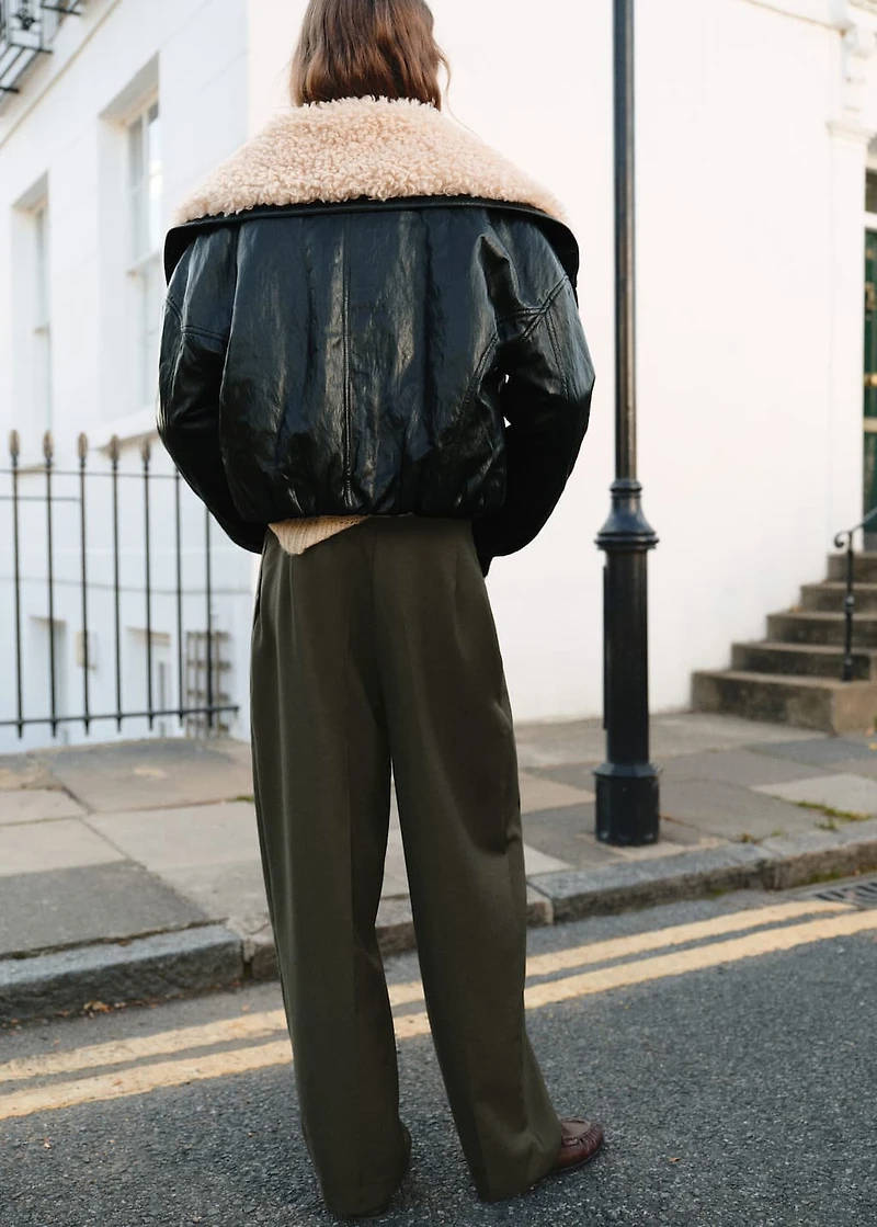 Trousers with pleats and button detail