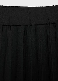 Pleated asymmetric skirt