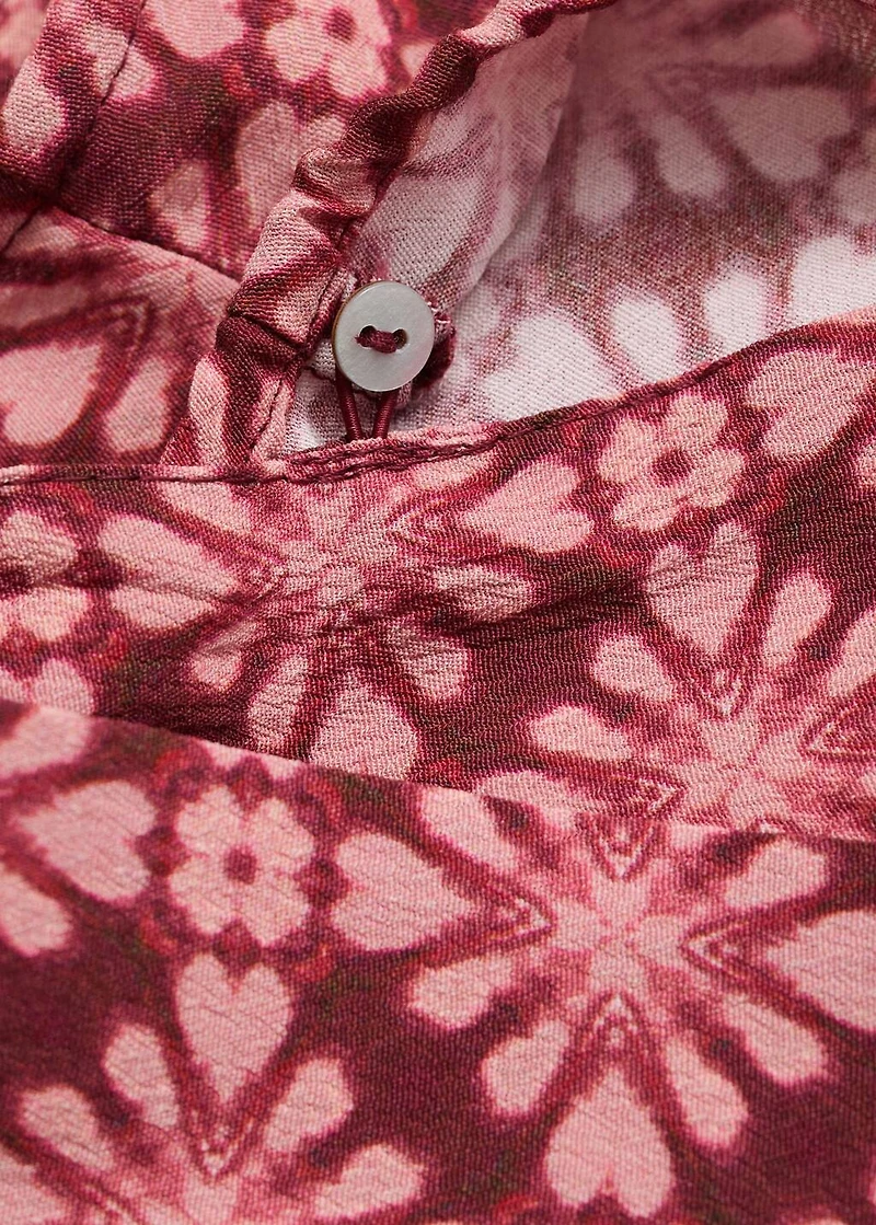 Asymmetrical blouse with bow at the neck