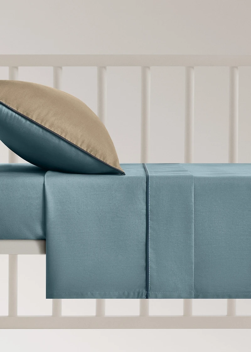 Reversible percale cotton top sheet with contrasting piping for cot