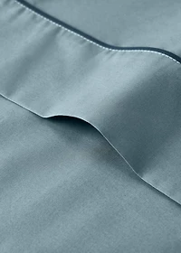Reversible percale cotton top sheet with contrasting piping for cot