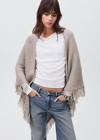 Knitted poncho with tassels