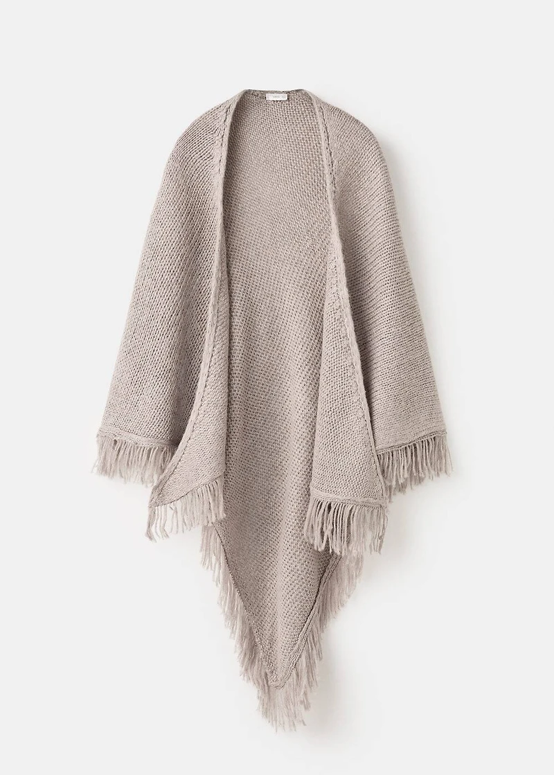 Knitted poncho with tassels