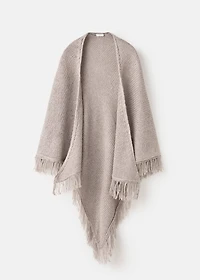 Knitted poncho with tassels