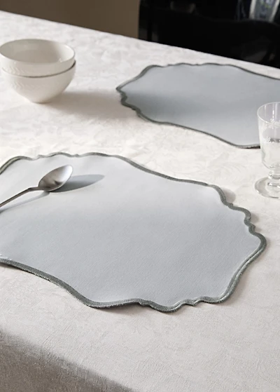Oval resin-coated placemat with wave pattern