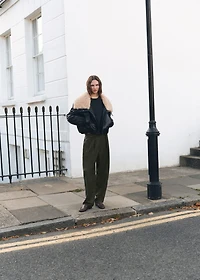 Trousers with pleats and button detail