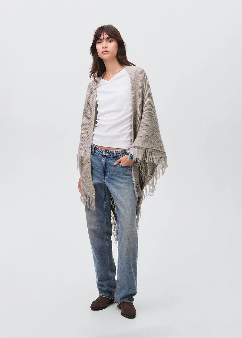 Knitted poncho with tassels