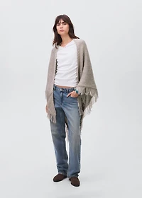 Knitted poncho with tassels