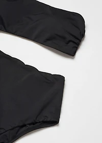Swimsuit with asymmetrical opening