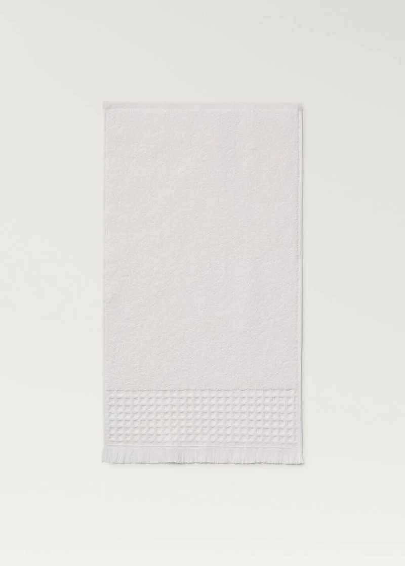 Hand towel with waffle trim and fringe