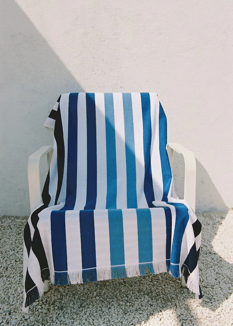 Beach towel with multi-colored stripes and fringes