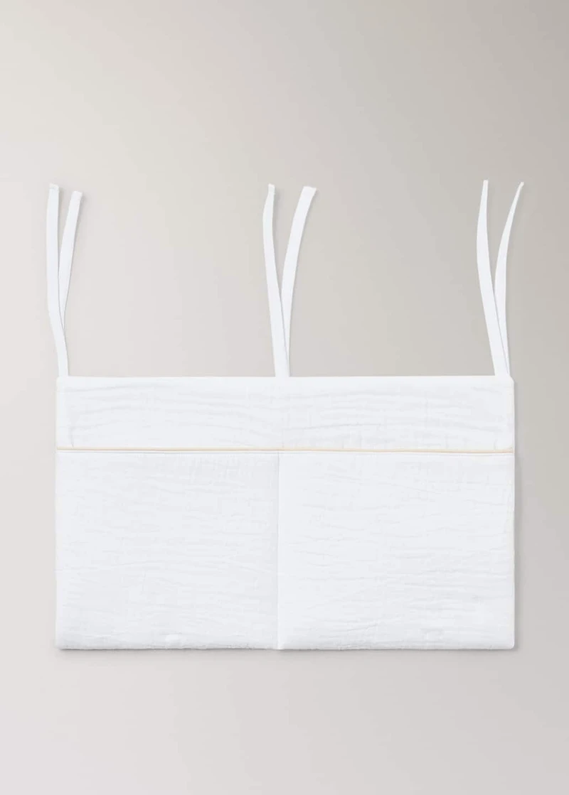 Cot organizer with piping