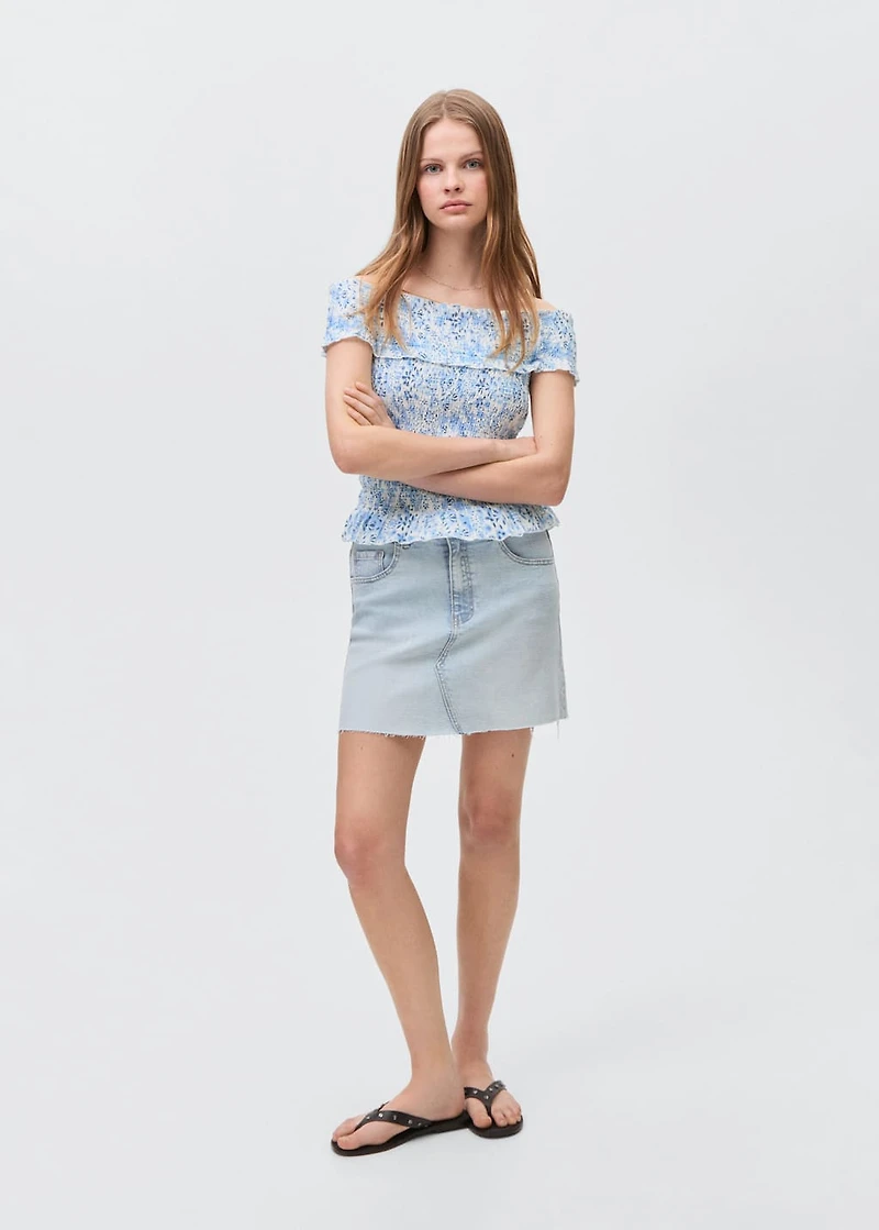 Denim miniskirt with frayed hem