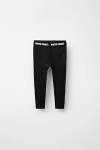 LEGGING CÔTELÉ AVEC INSCRIPTION EN RELIEF