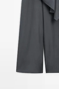 Asymmetric draped jumpsuit