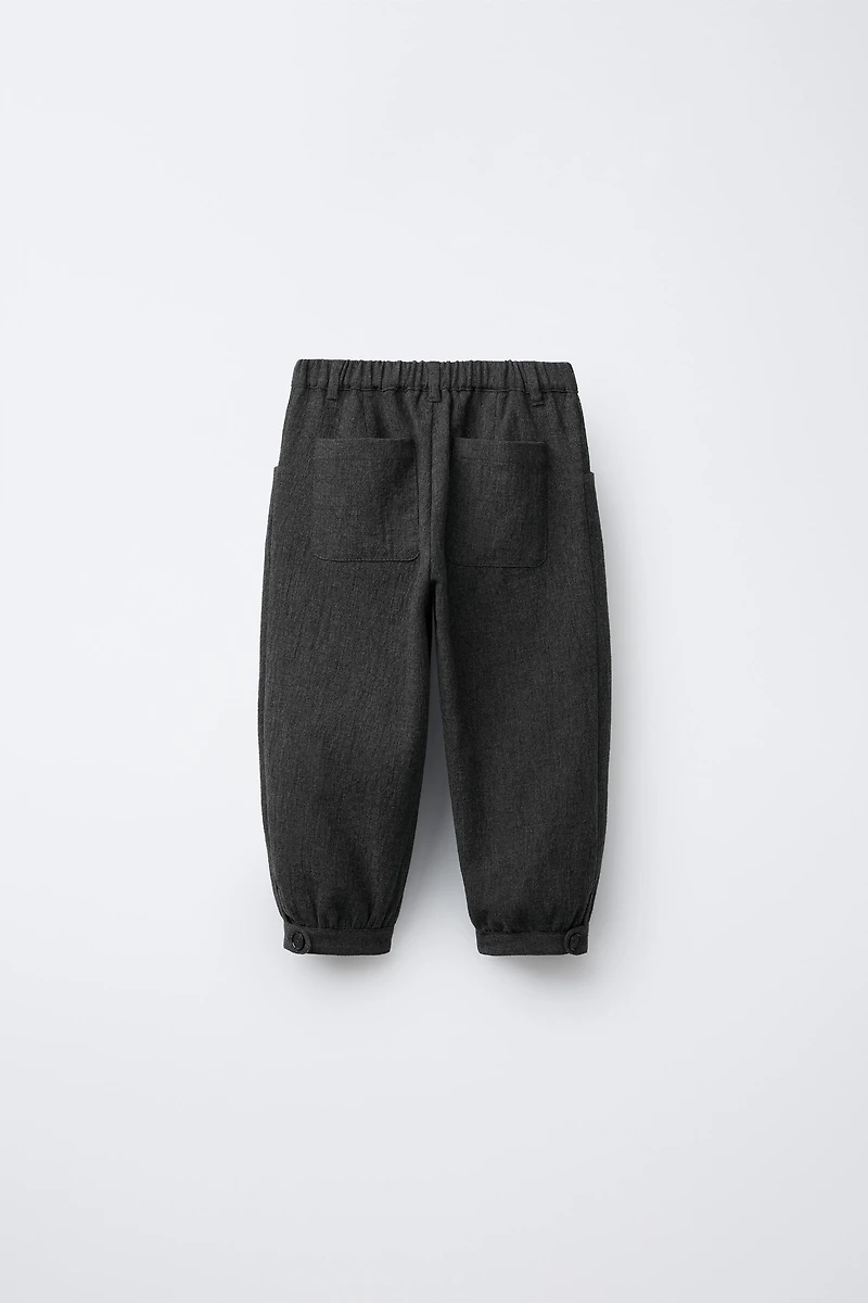 TEXTURED PLEATED PANTS