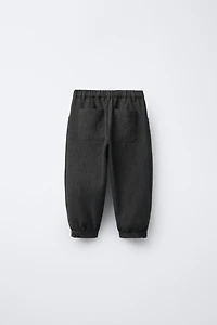 TEXTURED PLEATED PANTS