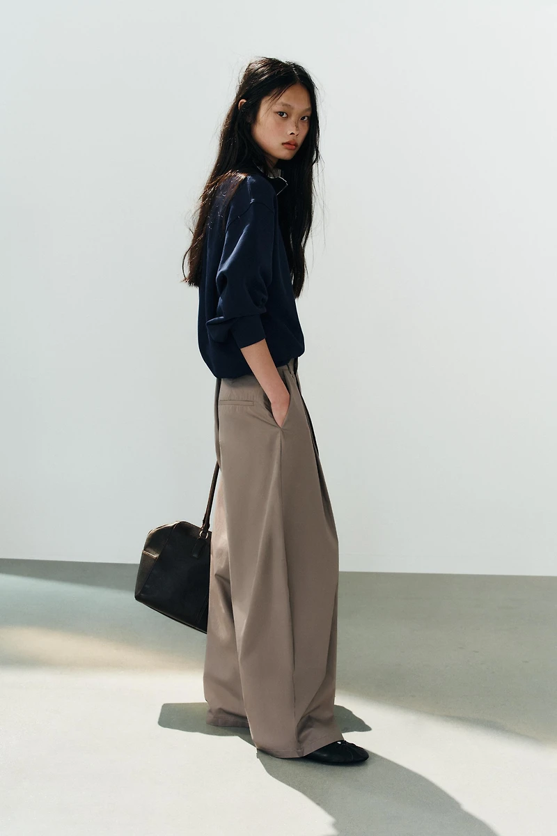 ASYMMETRIC WAIST PLEATED TROUSERS