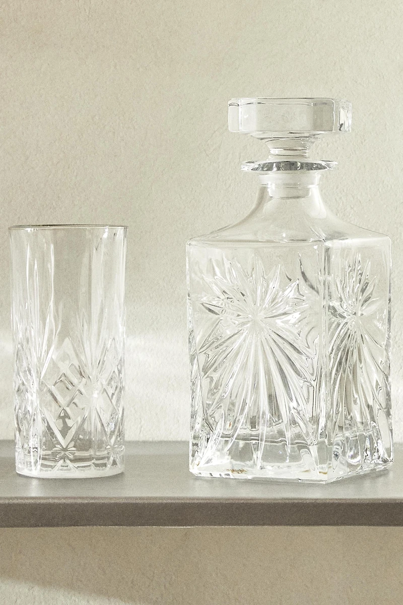 CRYSTALLINE BOTTLE WITH RAISED DESIGN