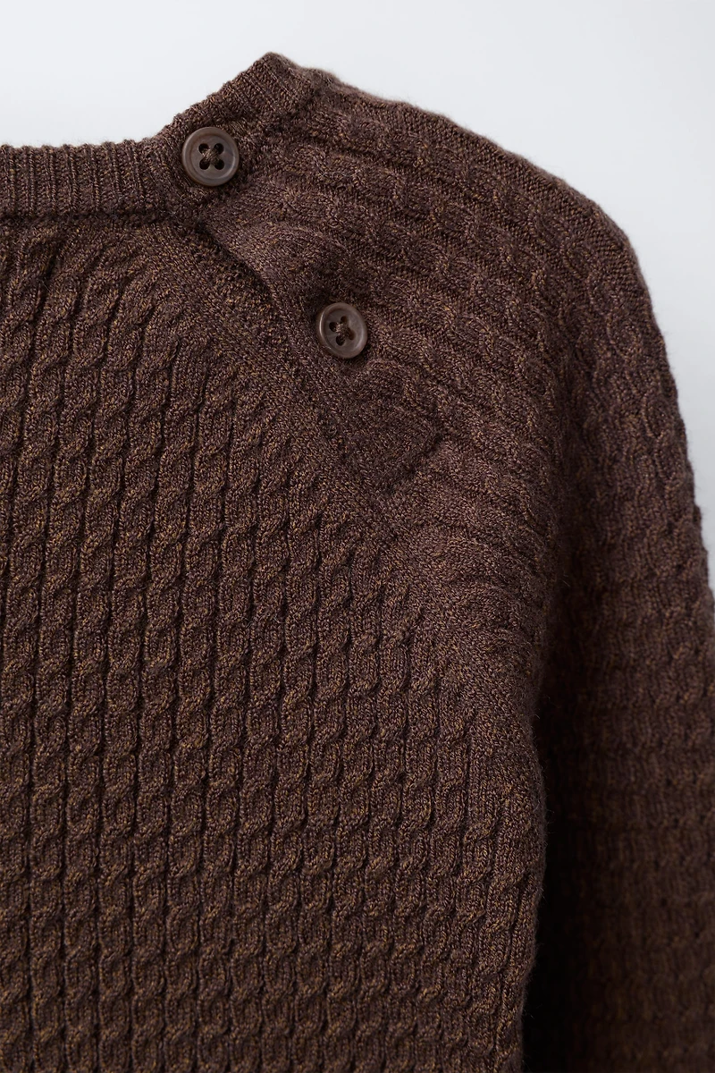 PULL EN MAILLE À TORSADES
