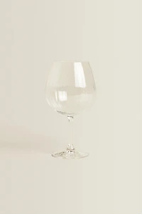 CRYSTALLINE GLASS WITH A RAISED DESIGN