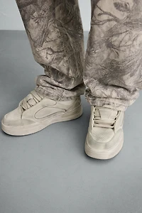 DISTRESSED THICK-SOLED SNEAKERS