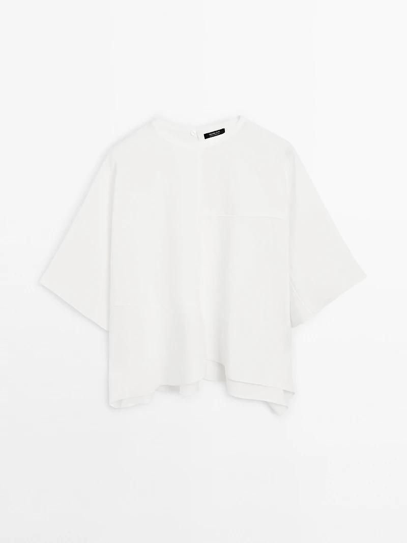 Short cape with seam details