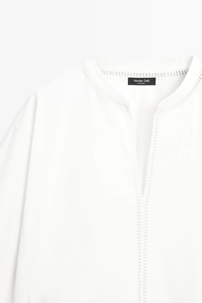 Embroidered blouse with fringed hem