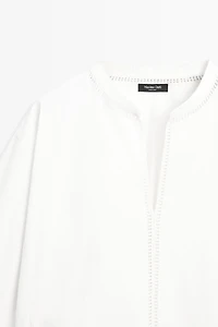 Embroidered blouse with fringed hem