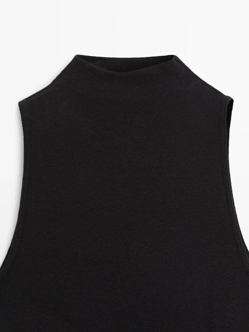 Funnel neck top with brooch detail