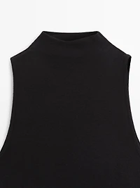 Funnel neck top with brooch detail