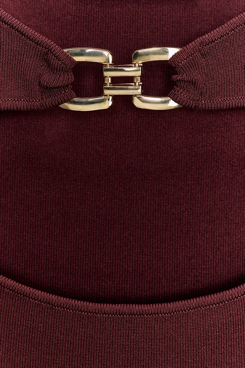 CUT OUT KNIT DRESS WITH METAL DETAIL